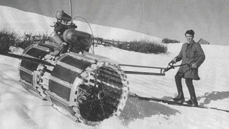 Two men manually roll the slope